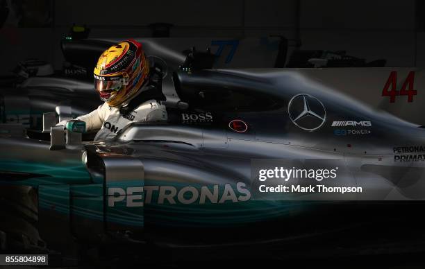 Pole position qualifier Lewis Hamilton of Great Britain and Mercedes GP stops in parc ferme during qualifying for the Malaysia Formula One Grand Prix...