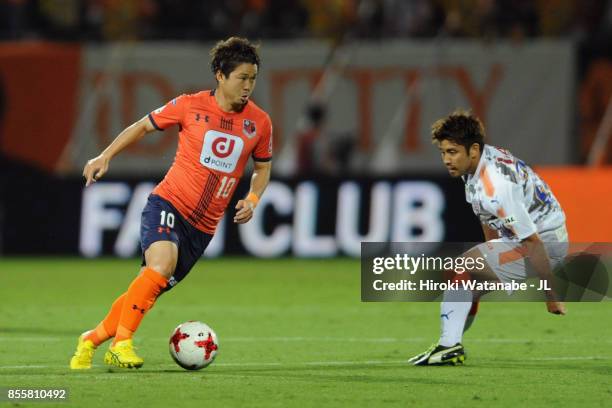 Genki Omae of Omiya Ardija Ryo controls the ball under pressure of Takeuchi of Shimizu S-Pulse during the J.League J1 match between Omiya Ardija and...