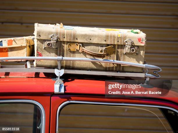 close-up of suitcases on car trunk, ancient car loaded with ancient suitcases of leather. valencia, spain - gepäckablage stock-fotos und bilder