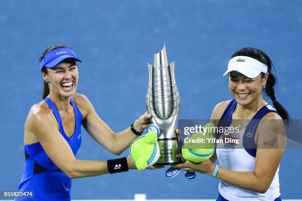 Martina Hingis and Yung-Jan Chan hold the champion trophy at the award ceremony after wnning the ladies doubles final between Martina Hingis of...