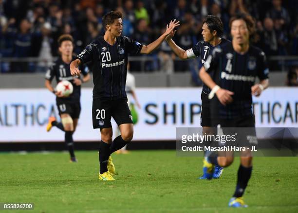 Shun Nagasawa of Gamba Osaka celebrates scoring his side's first goal with his team mates Yasuhito Endo during the J.League J1 match between Gamba...