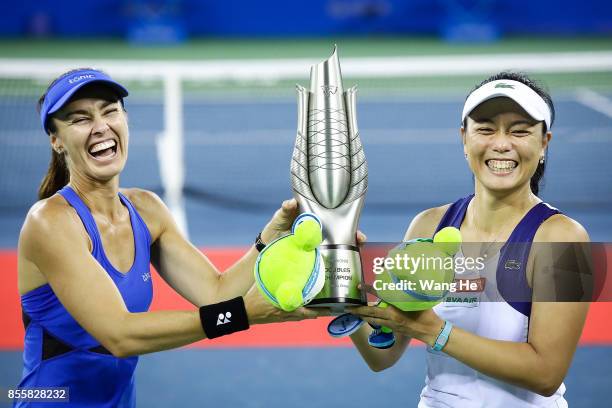 Martina Hingis of Switzerland and Yung Jan Chan of Chinese Taipei celebrate with the trophy following their victory during the Ladies Doubles final...