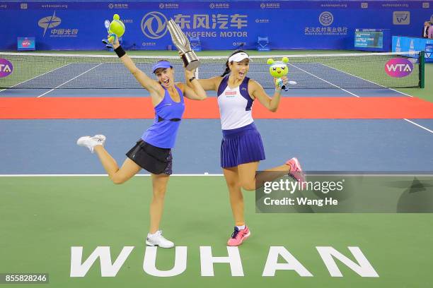 Martina Hingis of Switzerland and Yung Jan Chan of Chinese Taipei celebrate with the trophy following their victory during the Ladies Doubles final...