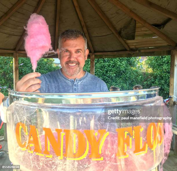 mature man working at candy floss stall - cotton candy machine stock pictures, royalty-free photos & images