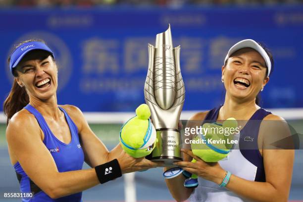 Martina Hingis of Switzerland and Yung Jan Chan of Chinese Taipei celebrate with the trophy following their victory during the Ladies Doubles final...