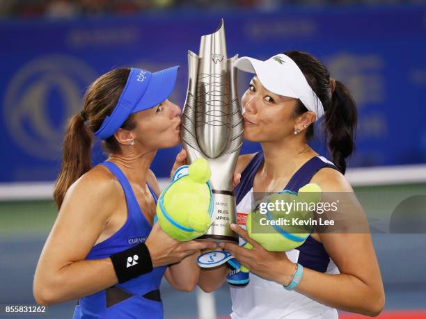 Martina Hingis of Switzerland and Yung Jan Chan of Chinese Taipei celebrate with the trophy following their victory during the Ladies Doubles final...