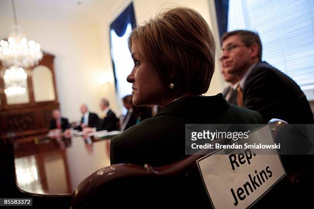 Representative Lynn Jenkins listens while others speak to the press on Capitol Hill March 24, 2009 in Washington, DC. House Minority Leader John...