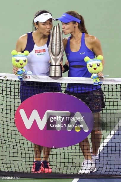 Martina Hingis and Yung-Jan Chan kiss the champion trophy at the award ceremony after wnning the ladies doubles final between Martina Hingis of...