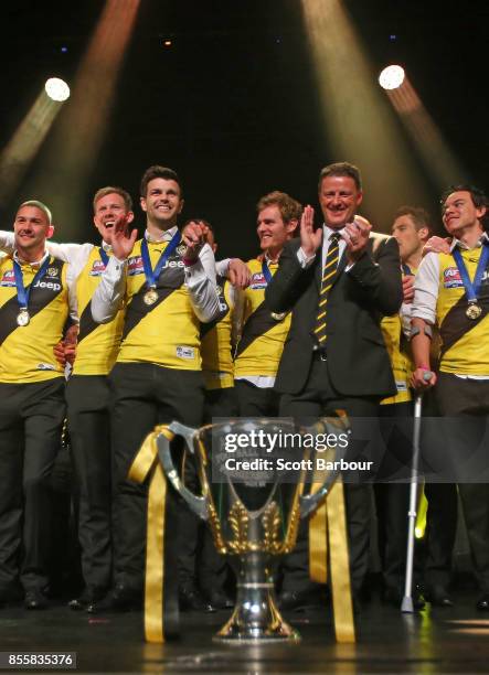 Captain Trent Cotchin of the Tigers and Damien Hardwick, coach of the Tigers smile as the Tigers celebrate with the AFL Premiership Cup on stage...