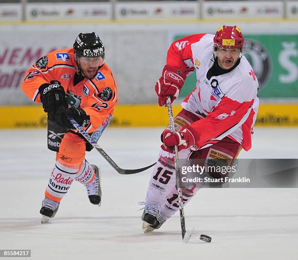 Dan Lambert of Hannover is challenged by Gregg Johnson of Wolfsburg during the DEL play-off match between Grizzly Adams Wolfsburg and Hannover...