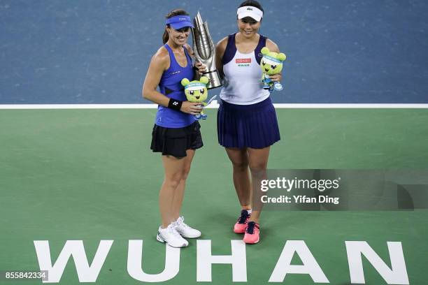 Martina Hingis and Yung-Jan Chan hold the champion trophy at the award ceremony after wnning the ladies doubles final between Martina Hingis of...