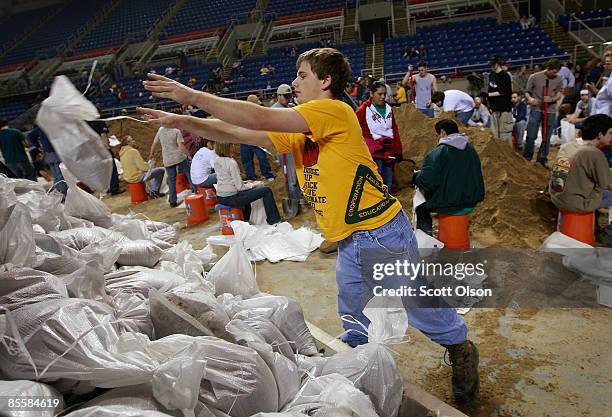 Philip Stenger piles newly-filled sandbags during a sandbagging operation at the Fargo Dome March 24, 2009 in Fargo, North Dakota. The city has...