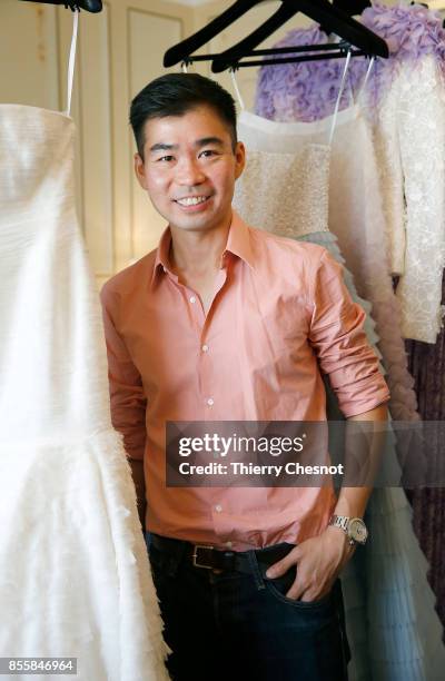 Thai fashion designer Ong-Oaj Pairam poses with his creations during a presentation as part of the Paris Fashion Week Womenswear Spring/Summer 2018...