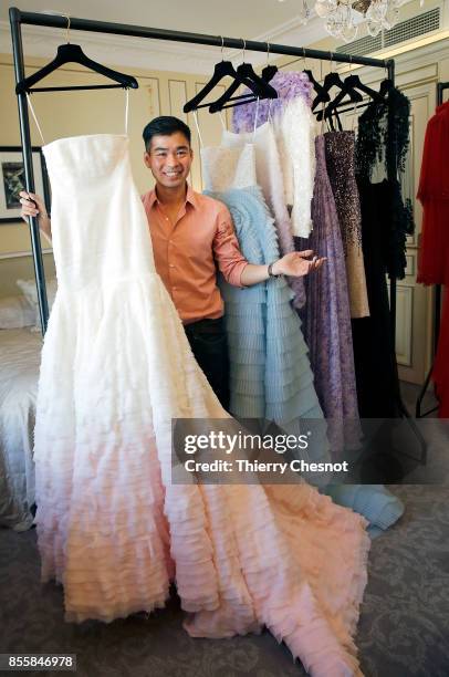 Thai fashion designer Ong-Oaj Pairam poses with his creations during a presentation as part of the Paris Fashion Week Womenswear Spring/Summer 2018...