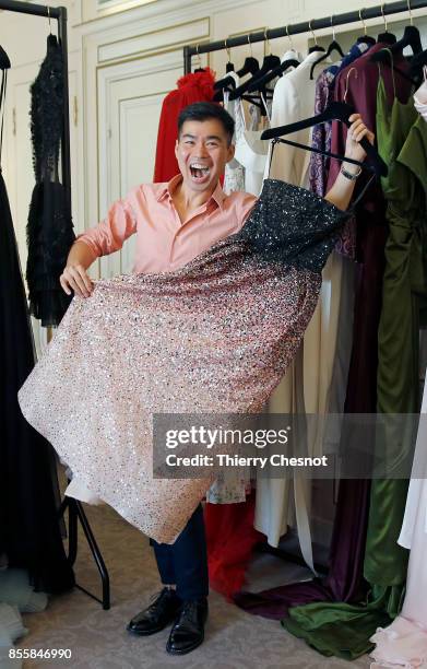 Thai fashion designer Ong-Oaj Pairam poses with his creations during a presentation as part of the Paris Fashion Week Womenswear Spring/Summer 2018...