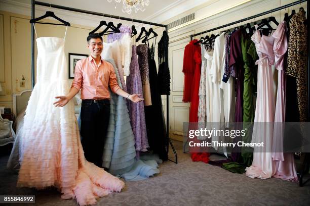 Thai fashion designer Ong-Oaj Pairam poses with his creations during a presentation as part of the Paris Fashion Week Womenswear Spring/Summer 2018...