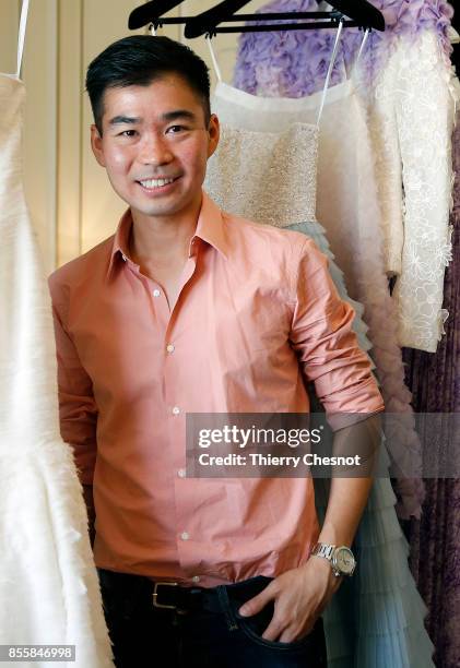 Thai fashion designer Ong-Oaj Pairam poses with his creations during a presentation as part of the Paris Fashion Week Womenswear Spring/Summer 2018...