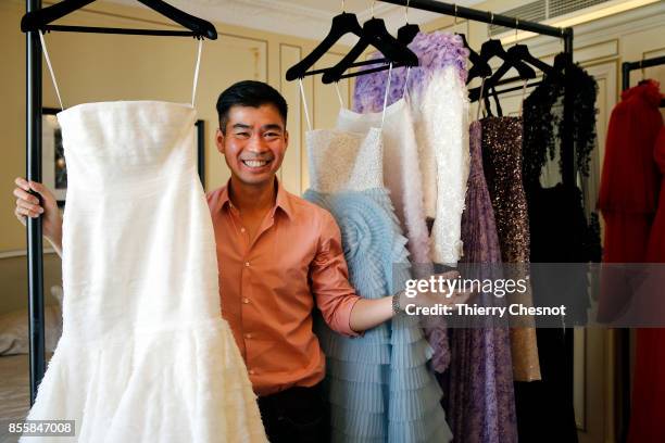 Thai fashion designer Ong-Oaj Pairam poses with his creations during a presentation as part of the Paris Fashion Week Womenswear Spring/Summer 2018...