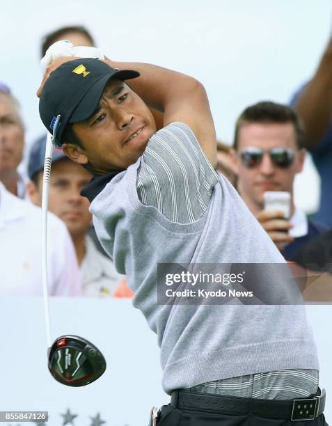 The international team's Hideki Matsuyama tees off on the ninth hole as he teamed up with Adam Hadwin against Patrick Reed and Jordan Spieth of the...
