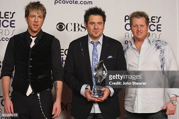 Musicians Joe Don Rooney, Jay DeMarcus and Gary LeVox of 'Rascal Flatts' pose in the press room at the 35th Annual People's Choice Awards held at the...