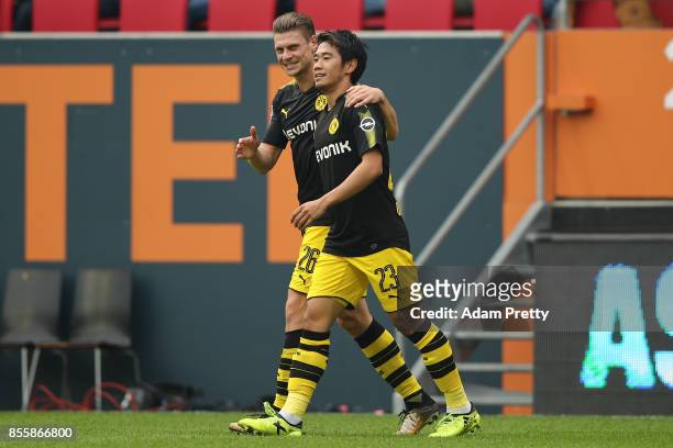 Shinji Kagawa of Dortmund celebrates with Lukasz Piszczek of Dortmund after he scored his teams second goal to make it 2:1 during the Bundesliga...
