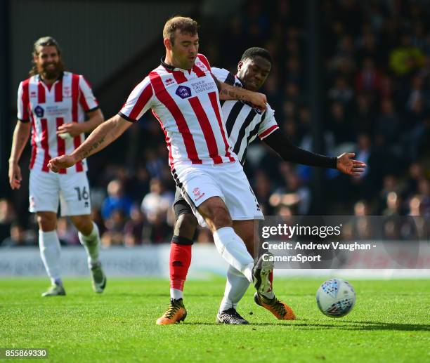 Lincoln City's Matt Rhead shields the ball from Grimsby Town's Mitch Rose during the Sky Bet League Two match between Grimsby Town and Lincoln City...