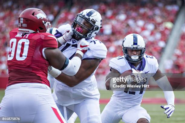 Kyle Hicks runs the ball behind the blocking of Lucas Niang of the TCU Horned Frogs during a game against the Arkansas Razorbacks at Donald W....