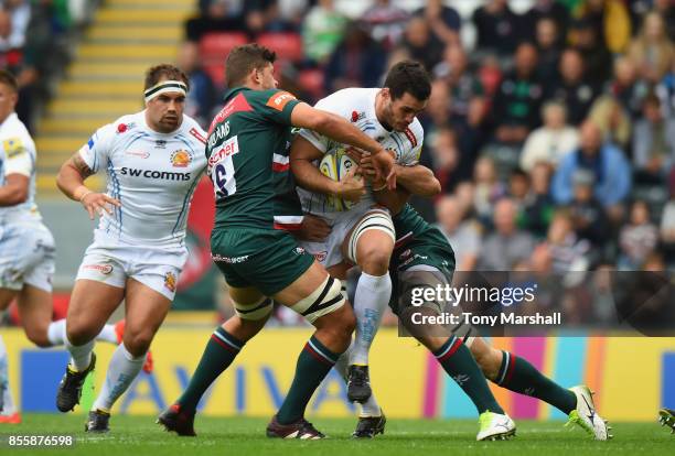 Mike Williams and Dom Barrow of Leicester Tigers tackle Dave Dennis of Exeter Chiefs during the Aviva Premiership match between Leicester Tigers and...