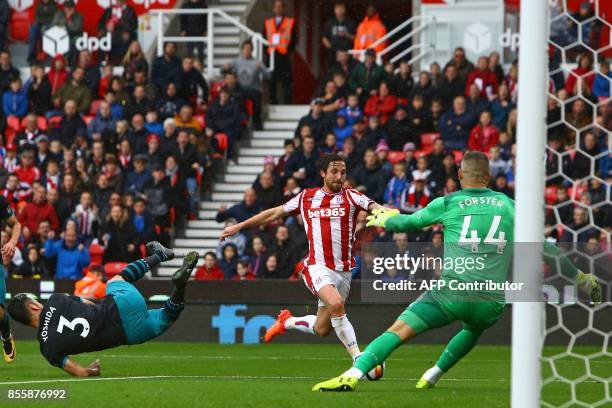 Stoke City's Welsh midfielder Joe Allen goes past Southampton's Japanese defender Maya Yoshida as Southampton's English goalkeeper Fraser Forster...