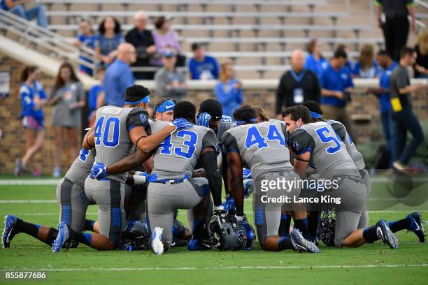 Jacob Morgenstern, Tinashe Bere, Joe Giles-Harris and Kevin Gehsmann of the Duke Blue Devils huddle with teammates prior to their game against the...