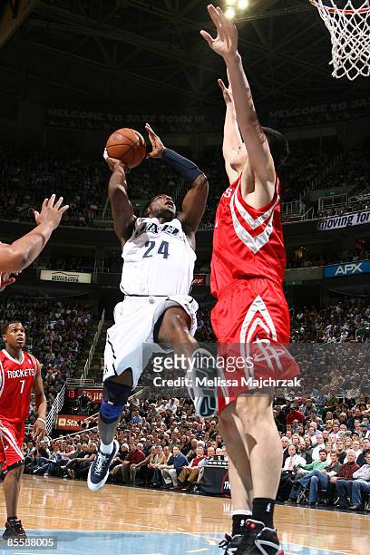Paul Millsap of the Utah Jazz goes for the shot as Yao Ming of the Houston Rockets tries to block at EnergySolutions Arena on March 24, 2009 in Salt...