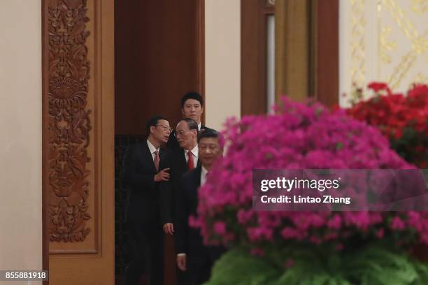 Chinese Vice-Premier Zhang Gaoli talk with Secretary of the Central Commission for Discipline Inspection Wang Qishan during the reception marking the...