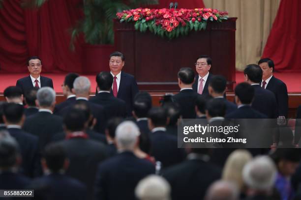 Chinese President Xi Jinping, Premier Li Keqiang and National People's Congress Chairman Zhang Dejiang attend a reception marking the 64th...