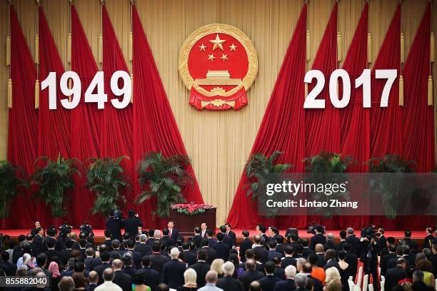 Chinese President Xi Jinping, Premier Li Keqiang and National People's Congress Chairman Zhang Dejiang attend a reception marking the 64th...