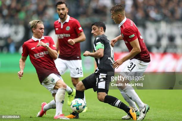 Felix Klaus of Hannover , Lars Stindl of Moenchengladbach and Anton Waldemar of Hannover battle for the ball during the Bundesliga match between...