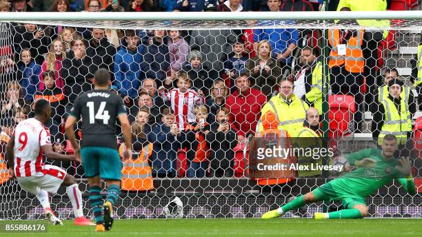 Fraser Forster of Southampton makes a save a penalty taken by Saido Berahino of Stoke City during the Premier League match between Stoke City and...
