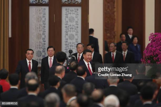 Chinese President Xi Jinping, Premier Li Keqiang and National People's Congress Chairman Zhang Dejiang attend a reception marking the 64th...