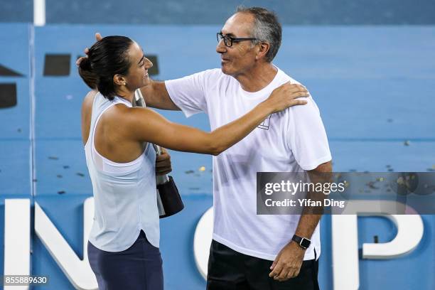 Caroline Garcia celebrates with her father and coach Louis Paul Garcia at the award ceremony after winning the ladies singles final between Ashleigh...