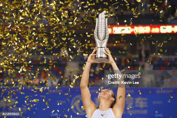 Caroline Garcia of France poses with her trophy after defeating Ashleigh Barty of Australia in the Finals match of Women's Single of 2017 Wuhan Open...