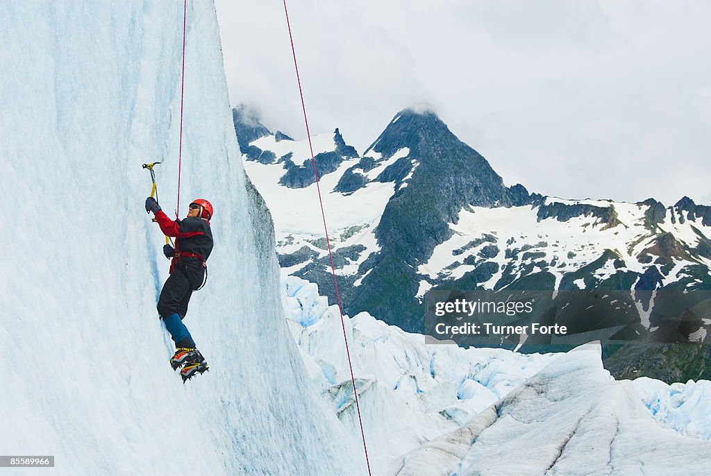 Woman climbs glacial cliff