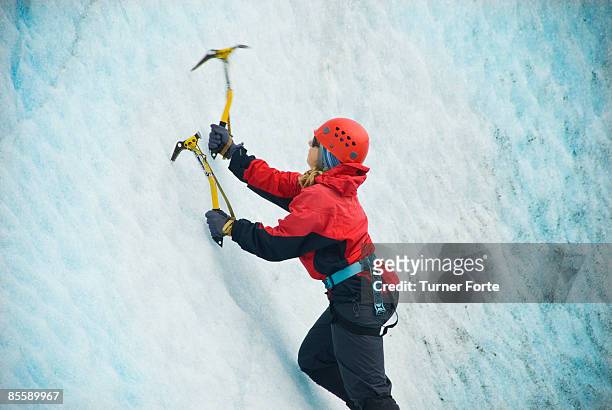 woman climbs ice wall on glacier - ice pick ストックフォトと画像