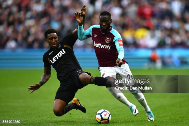 Arthur Masuaku of West Ham United is tackled by Leroy Fer of Swansea City during the Premier League match between West Ham United and Swansea City at...