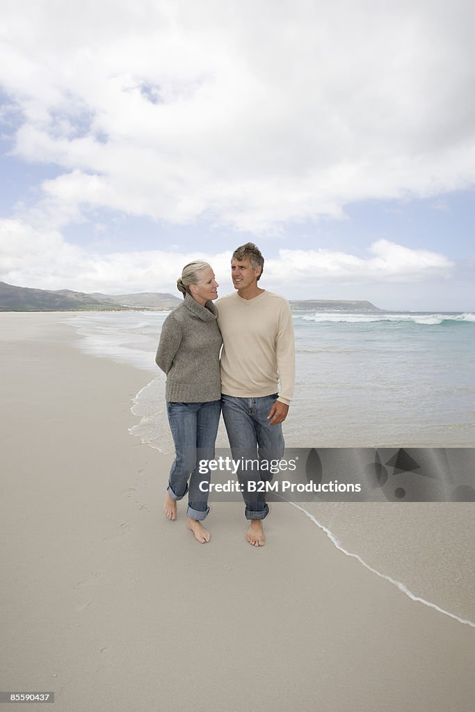 Senior couple walking on beach