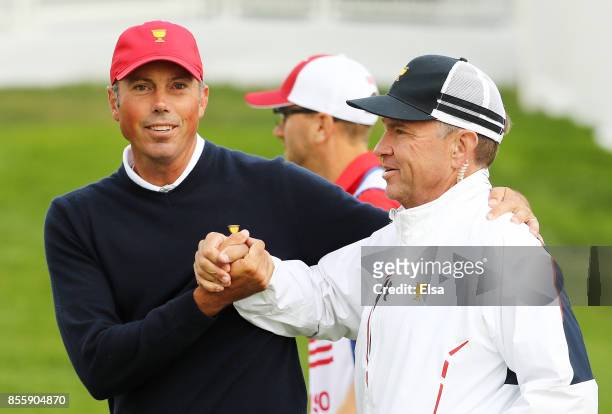Matt Kuchar celebrates with Captain's assistant Davis Love III after Kuchar and Dustin Johnson of the U.S. Team defeated Adam Hadwin of Canada and...