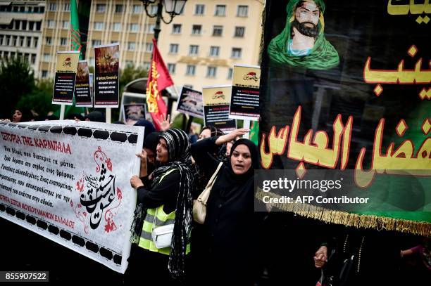 Woman gestures as Shiite muslim migrants to Greece take part in a procession in central Athens to mark the Shiite religious holiday of Ashura on...