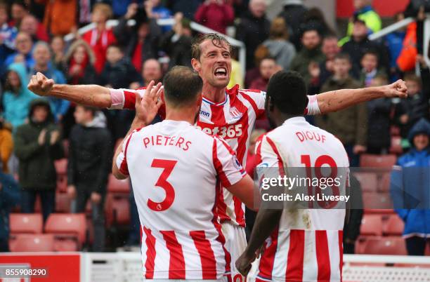 Peter Crouch of Stoke City celebrates scoring his sides second goal with his team mates Erik Pieters and Mame Biram Diouf during the Premier League...