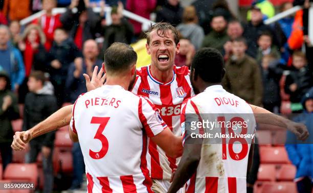 Peter Crouch of Stoke City celebrates scoring his sides second goal with his team mates Erik Pieters and Mame Biram Diouf during the Premier League...