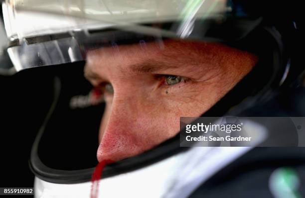 Blake Koch, driver of the LeafFilter Gutter Protection Chevrolet, looks on during qualifying for the NASCAR XFINITY Series "Use Your Melon. Drive...
