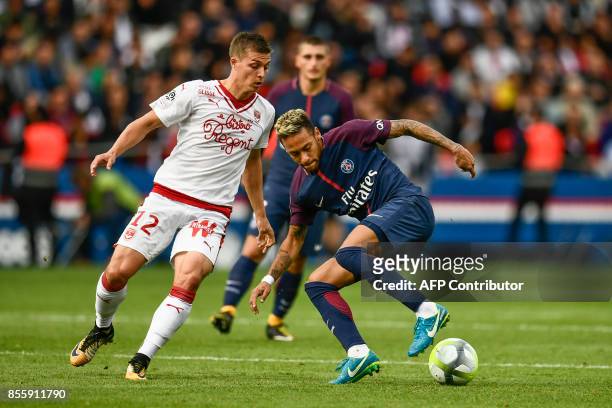 Paris Saint-Germain's Brazilian forward Neymar dribbles Bordeaux's French forward Nicolas De Preville during the French L1 football match Paris...