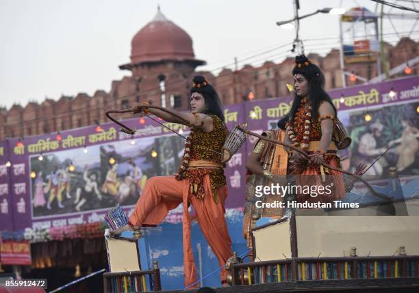 An artist plays the role of Ram and uses bow and arrow during the Dussehra festival celebration organised by Shri Dharmik Leela Committee at Lal...